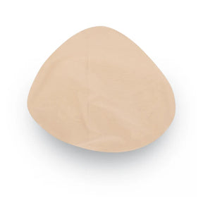 A single beige silicone or latex breast implant cup shown from a top-down view on a white background. - okotoks hc pharmacy