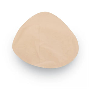 A single beige silicone or latex breast implant cup shown from a top-down view on a white background. - okotoks hc pharmacy