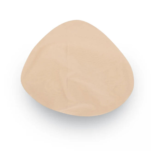 A single beige silicone or latex breast implant cup shown from a top-down view on a white background. - okotoks hc pharmacy