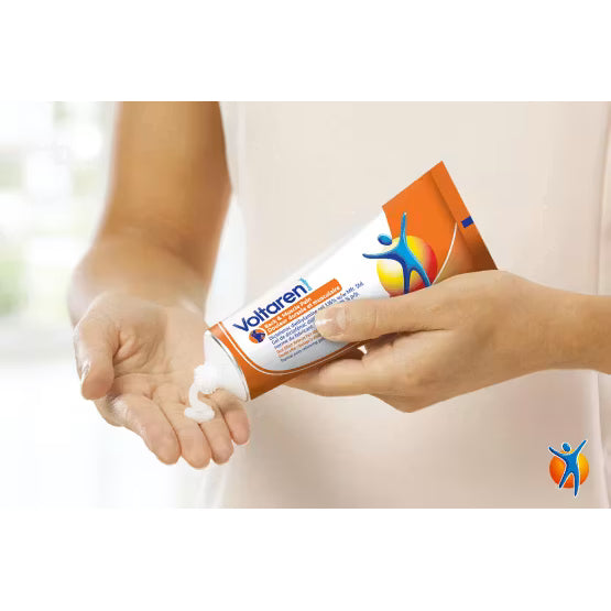 Person applying Voltaren cream to their hand with a focus on the product packaging. - okotoks hc pharmacy