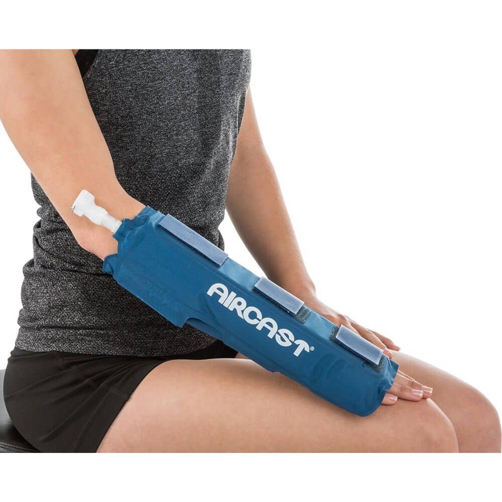 Person using a blue Aircast compression device on their arm. - okotoks hc pharmacy