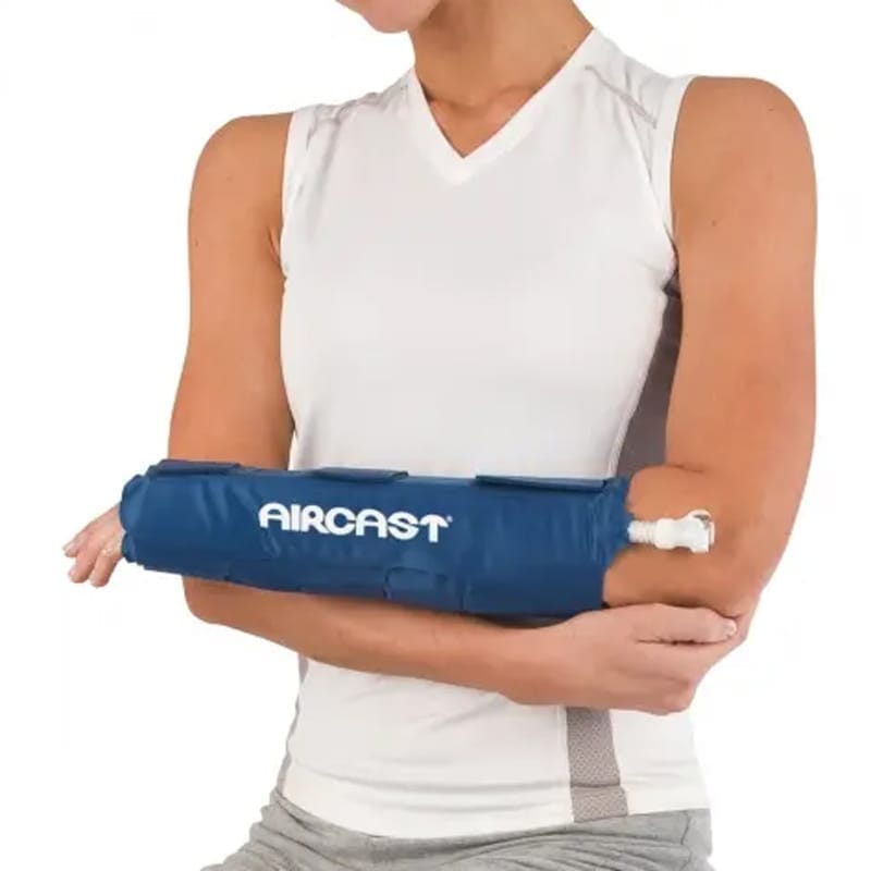 Person wearing a blue Aircast arm brace on a white background - okotoks hc pharmacy