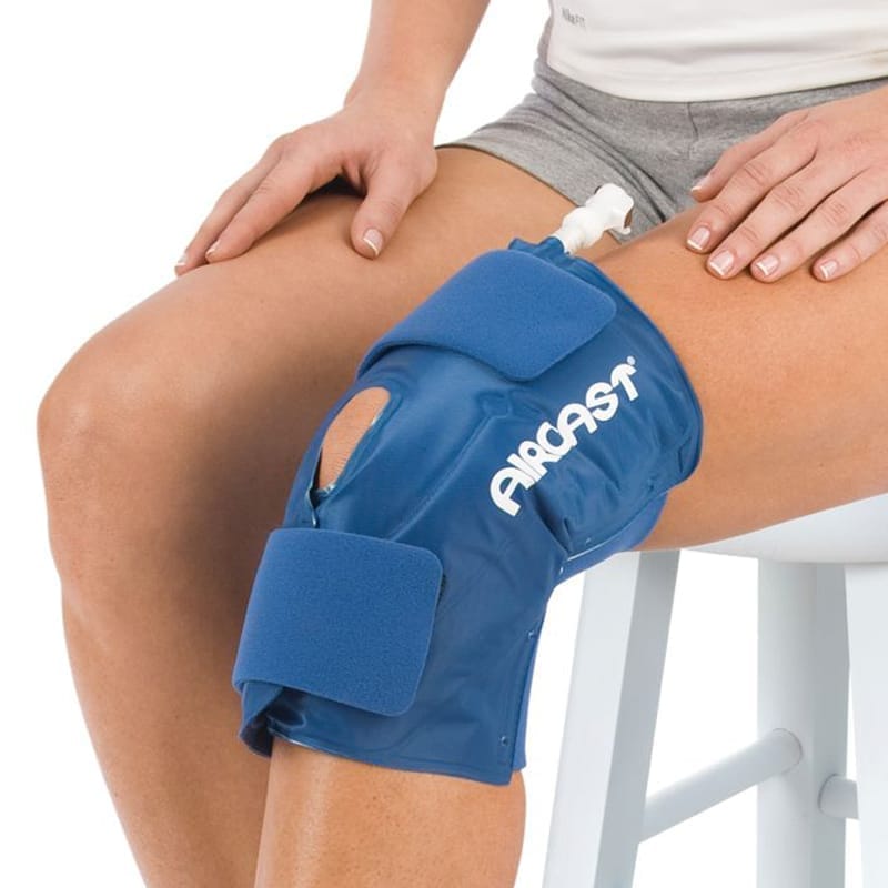 Blue Aircast knee brace on a person's knee with a white background - okotoks hc pharmacy