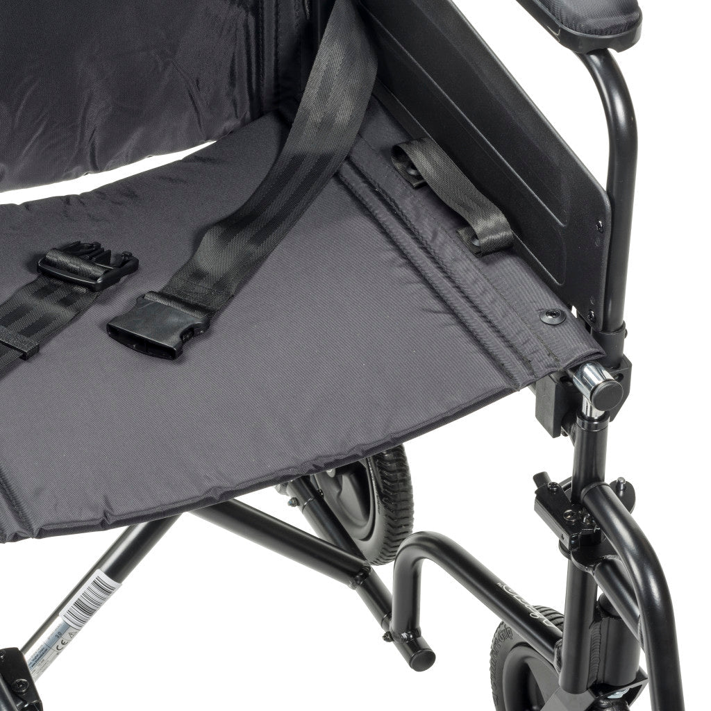 Close-up of a black wheelchair with a folded seat cover on a white background - okotoks hc pharmacy