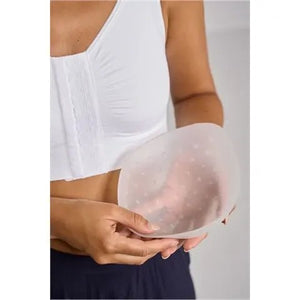 Person holding a silicone bra pad against a neutral background - okotoks hc pharmacy
