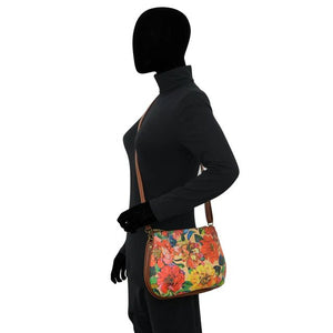 Mannequin wearing a black outfit with a colorful floral handbag on a white background - okotoks hc pharmacy