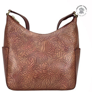 Brown leather handbag with floral patterns on a white background - okotoks hc pharmacy