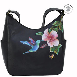 Black handbag with a colorful hummingbird and flower design on a white background - okotoks hc pharmacy
