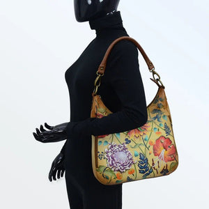 Person wearing a black outfit with a floral handbag on a white background - okotoks hc pharmacy