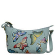 Light blue handbag with colorful butterfly designs on a white background - okotoks hc pharmacy