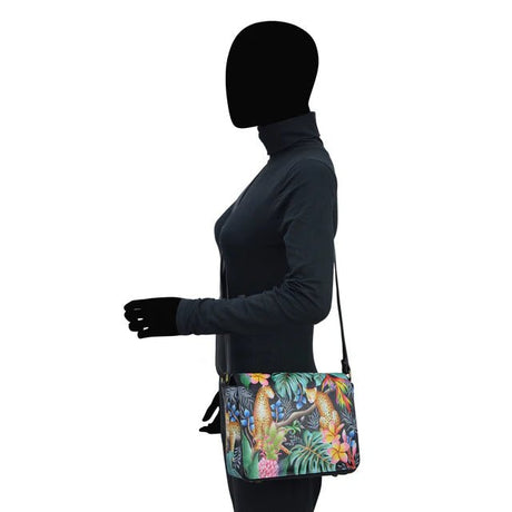 Person wearing a black jacket and gloves with a colorful bag featuring parrot design - okotoks hc pharmacy