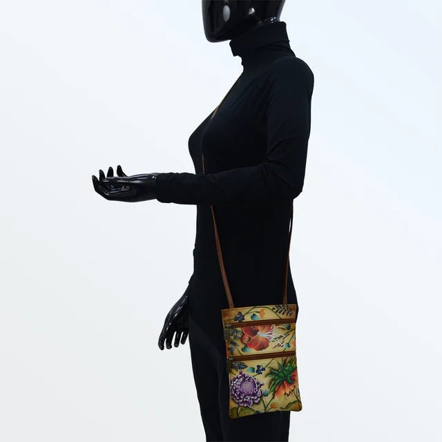 Person wearing a black outfit with a colorful floral bag on a white background - okotoks hc pharmacy