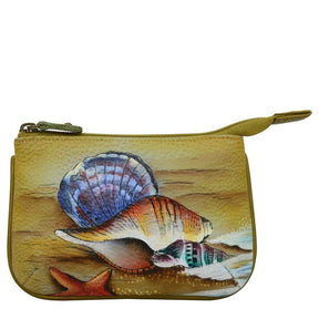 Hand-painted shell design on a small pouch with a white background - okotoks hc pharmacy