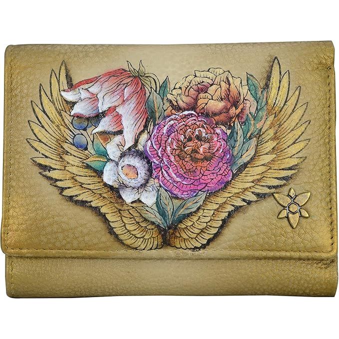 Leather wallet with floral design and wings on a beige background - okotoks hc pharmacy