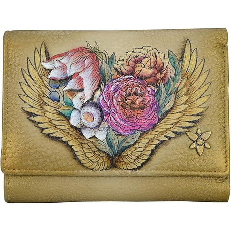 Leather wallet with floral design and wings on a beige background - okotoks hc pharmacy