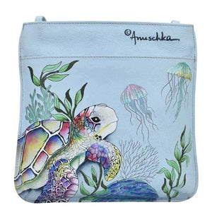 Handbag with a turtle and jellyfish design on a light blue background, featuring the brand 'Anuschka'. - okotoks hc pharmacy