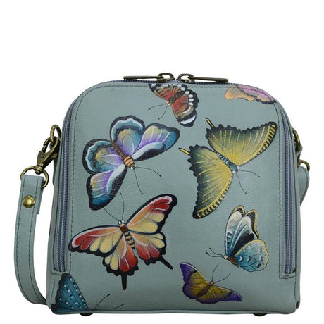 Light blue handbag with colorful butterfly designs on a white background - okotoks hc pharmacy