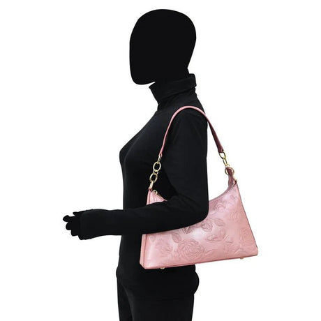 Person holding a pink handbag with a white background - okotoks hc pharmacy