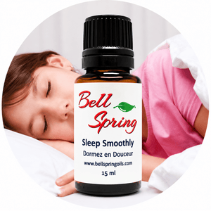 A 15 ml amber glass bottle of Bell Spring Sleep Smoothly essential oil with a black cap and white label, shown in front of a circular background depicting a sleeping child. - okotoks hc pharmacy