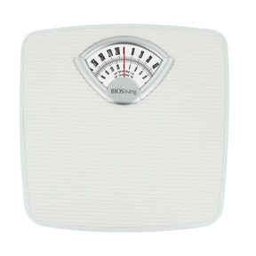 White mechanical bathroom scale with a dial on a white background - okotoks hc pharmacy