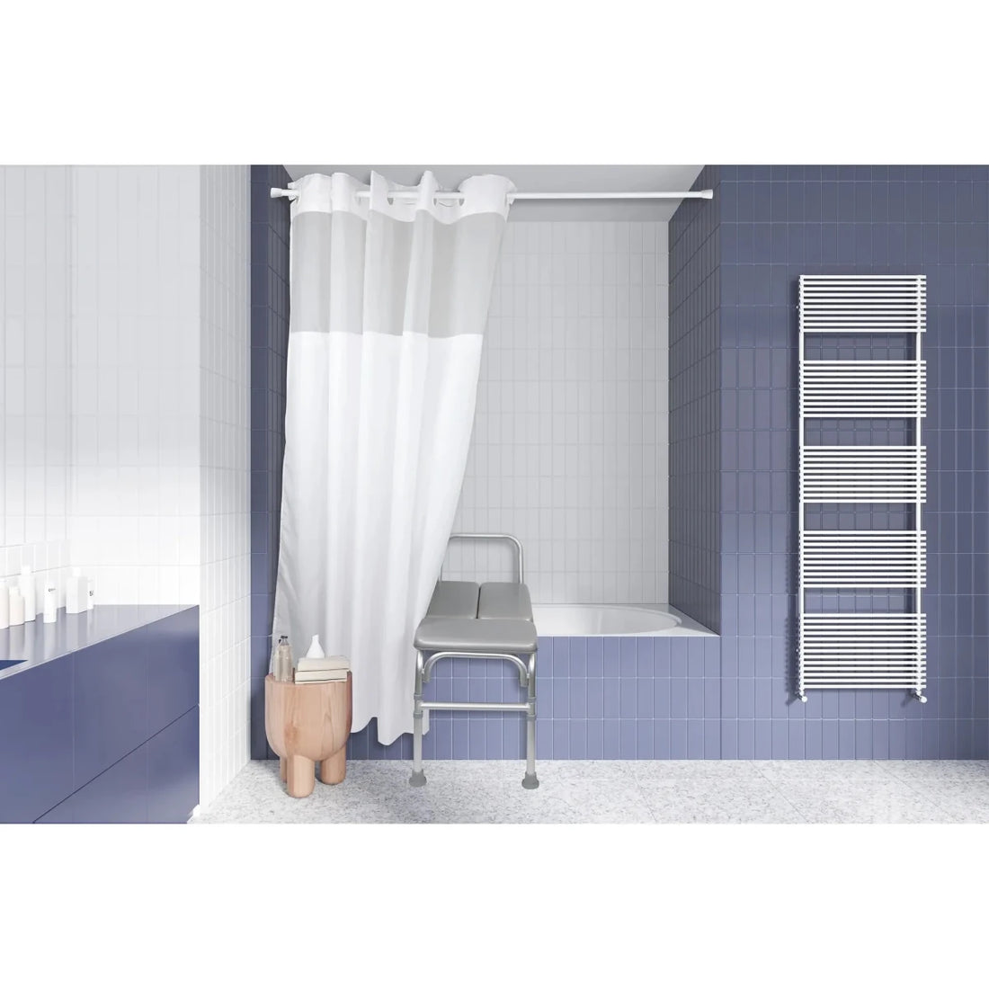 A modern bathroom interior with blue tiled walls, a white shower curtain, a bathtub, a metal examination-style stool, and a white heated towel rail. - okotoks hc pharmacy