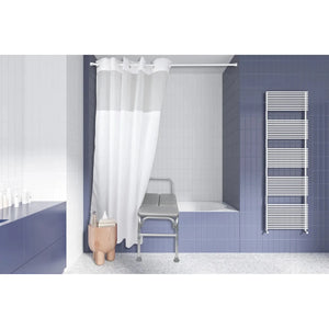 A modern bathroom interior with blue tiled walls, a white shower curtain, a bathtub, a metal examination-style stool, and a white heated towel rail. - okotoks hc pharmacy