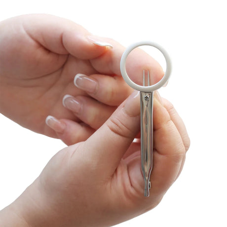 Small tweezers held between fingers on a white background - okotoks hc pharmacy