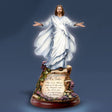 Statue of Jesus figure with outstretched arms on a dark blue background - okotoks hc pharmacy