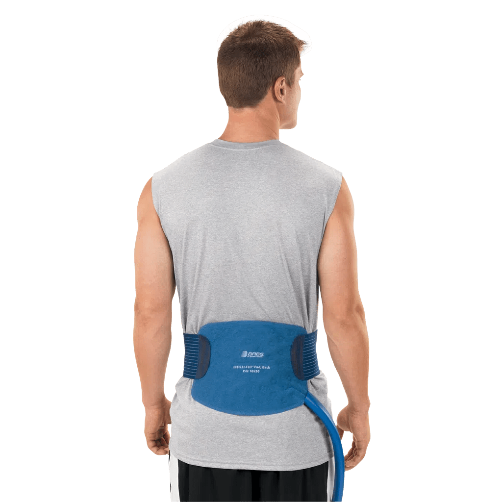 Man wearing a blue back brace on a white background - okotoks hc pharmacy
