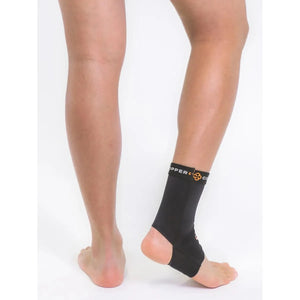 Person wearing a black ankle support brace on a white background - okotoks hc pharmacy