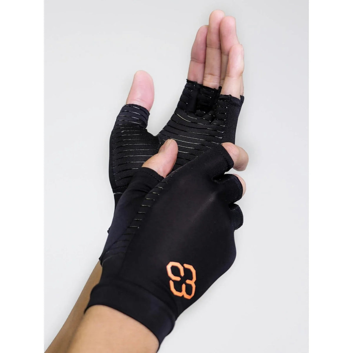 Black fingerless gloves with an orange logo on a white background - Okotoks hc pharmacy