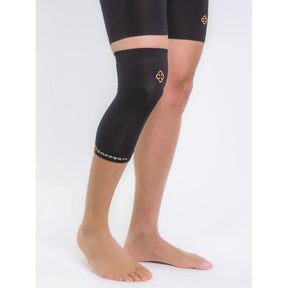 Black knee brace on a person's knee with a white background - okotoks hc pharmacy
