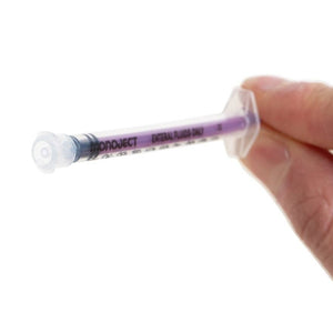 Hand holding a Monoject syringe with a white background - okotoks hc pharmacy