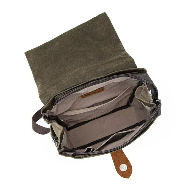 Green waxed canvas bag with a brown leather strap on a white background - okotoks hc pharmacy