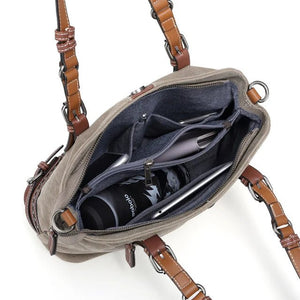 Open bag with brown straps showing a coffee cup and other items on a white background - okotoks hc pharmacy