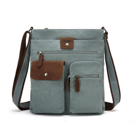 Light blue crossbody bag with brown leather accents on a white background - okotoks hc pharmacy