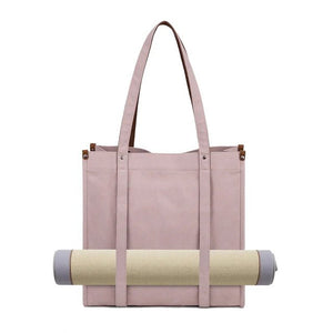 Pink tote bag with a rolled-up yoga mat on a white background - okotoks hc pharmacy