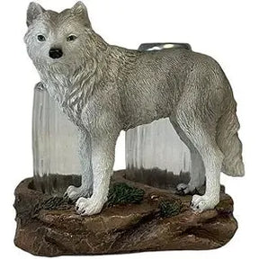 Statue of a wolf on a rock with a scenic background - okotoks hc pharmacy