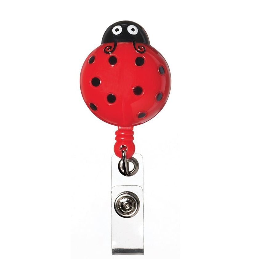 Red ladybug-shaped badge holder on a white background - okotoks hc pharmacy