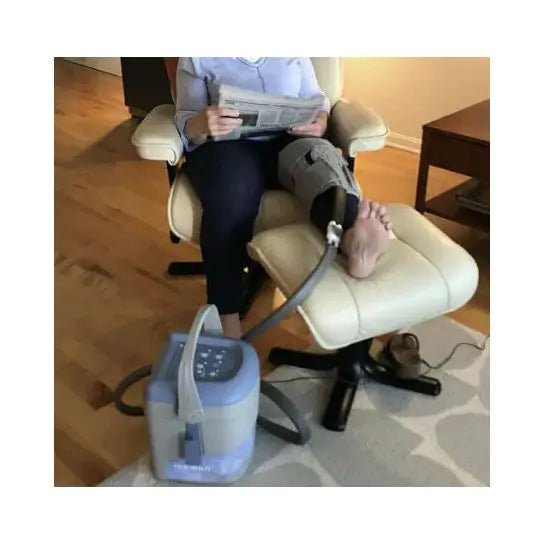 Person using a leg elevation device with a machine on the floor. - okotoks hc pharmacy