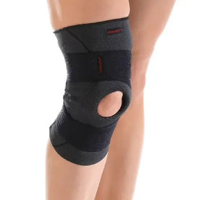 Black knee brace on a person's knee with a white background - okotoks hc pharmacy