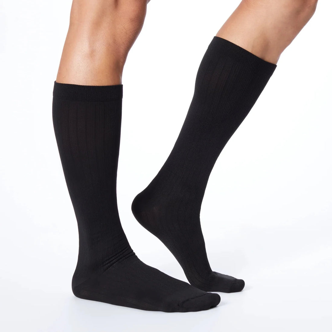 Black knee-high socks worn by a person on a white background - okotoks hc pharmacy