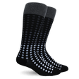 A pair of black crew socks with a gray ribbed cuff and a pattern of small light blue and white dots that fade into black toward the toes, shown on a white background. - okotoks hc pharmacy