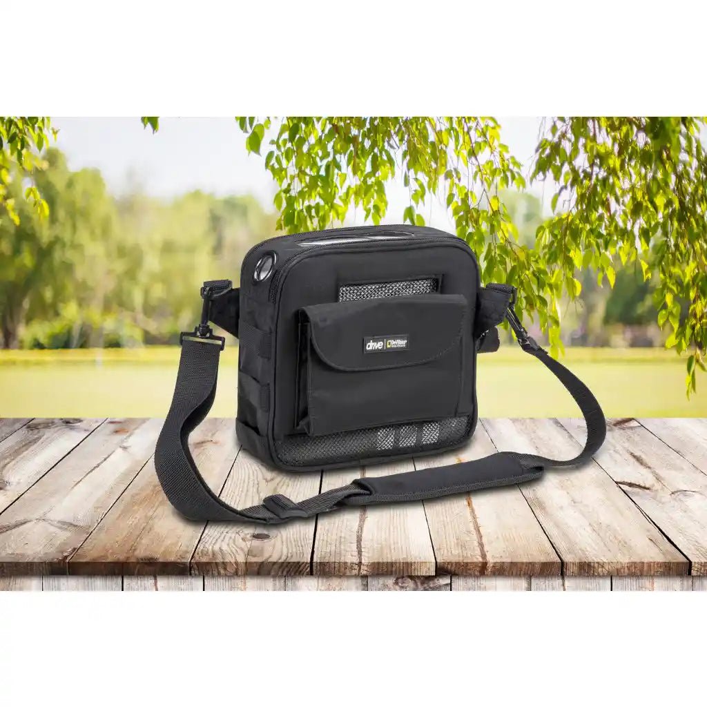derive portable oxygen concentrator in a black carrying case on a green outdoor background