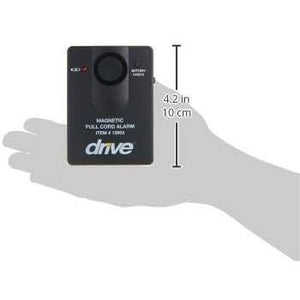 A small black magnetic full-cord alarm with the brand name 'drive' printed in white on the front, shown resting on a gray hand silhouette for scale. White measurement text and arrows indicate 4. - okotoks hc pharmacy