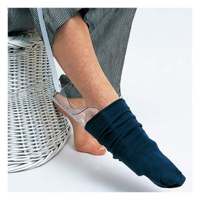 Person wearing a navy sock with a clear sandal on a white background - okotoks hc pharmacy