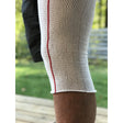 Close-up of a person wearing a white sleeve with a red stripe on a blurred outdoor background - okotoks hc pharmacy
