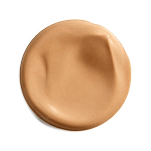 A circular smear of light tan liquid foundation or cream makeup on a plain white background. - okotoks hc pharmacy