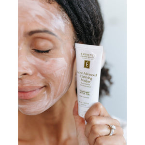 Woman applying Eminence Acne Advanced Clarifying Masque to her face. - okotoks hc pharmacy