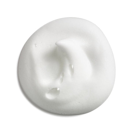 A dollop of thick, creamy white cosmetic product, likely a moisturizer or facial cream, with a smooth, textured surface and small water droplets on a clean white background. - okotoks hc pharmacy
